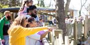 family pointing at animals