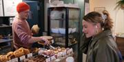 Person serving cakes in bakery