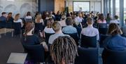 People seated and listening to a lecture