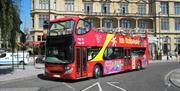 Red "Bath CitySightseeing" open-top bus.