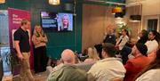 A group of people listening to two people running a digital marketing session