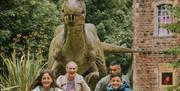 Wookey Hole - family running from dinosaurs